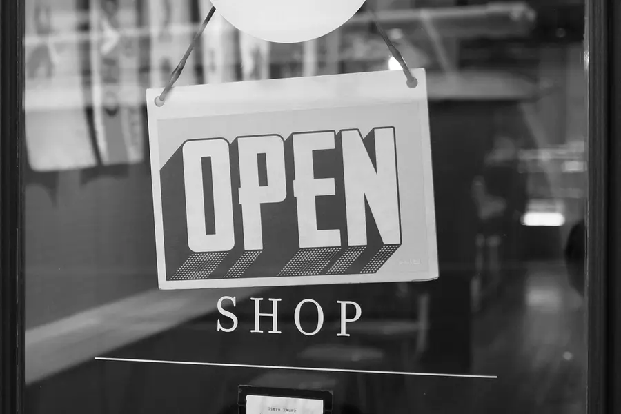 An open sign hanging in a shop window